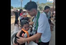 Male Student Honors Sister by Placing His Medals on Her at Graduation
