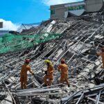 Rescuers search for more than 20 trapped after Philippines building collapse