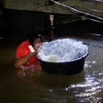 Baby Placed Inside Plastic Bag to Be Rescued From Deep Floodwaters