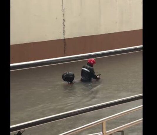 Rider Pushes Motorcycle Through Waist-Deep Flood in Makati
